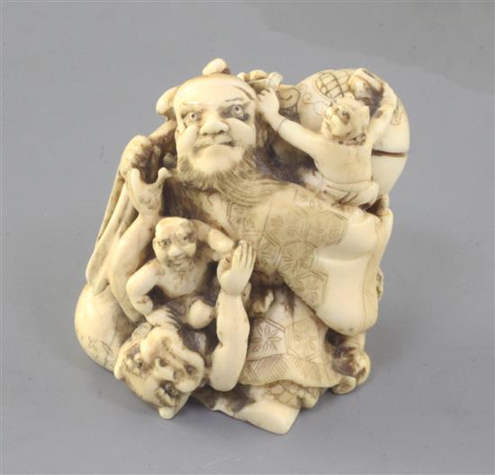 A Japanese ivory okimono netsuke of Shoki and oni, Meiji period, height 5.1cm